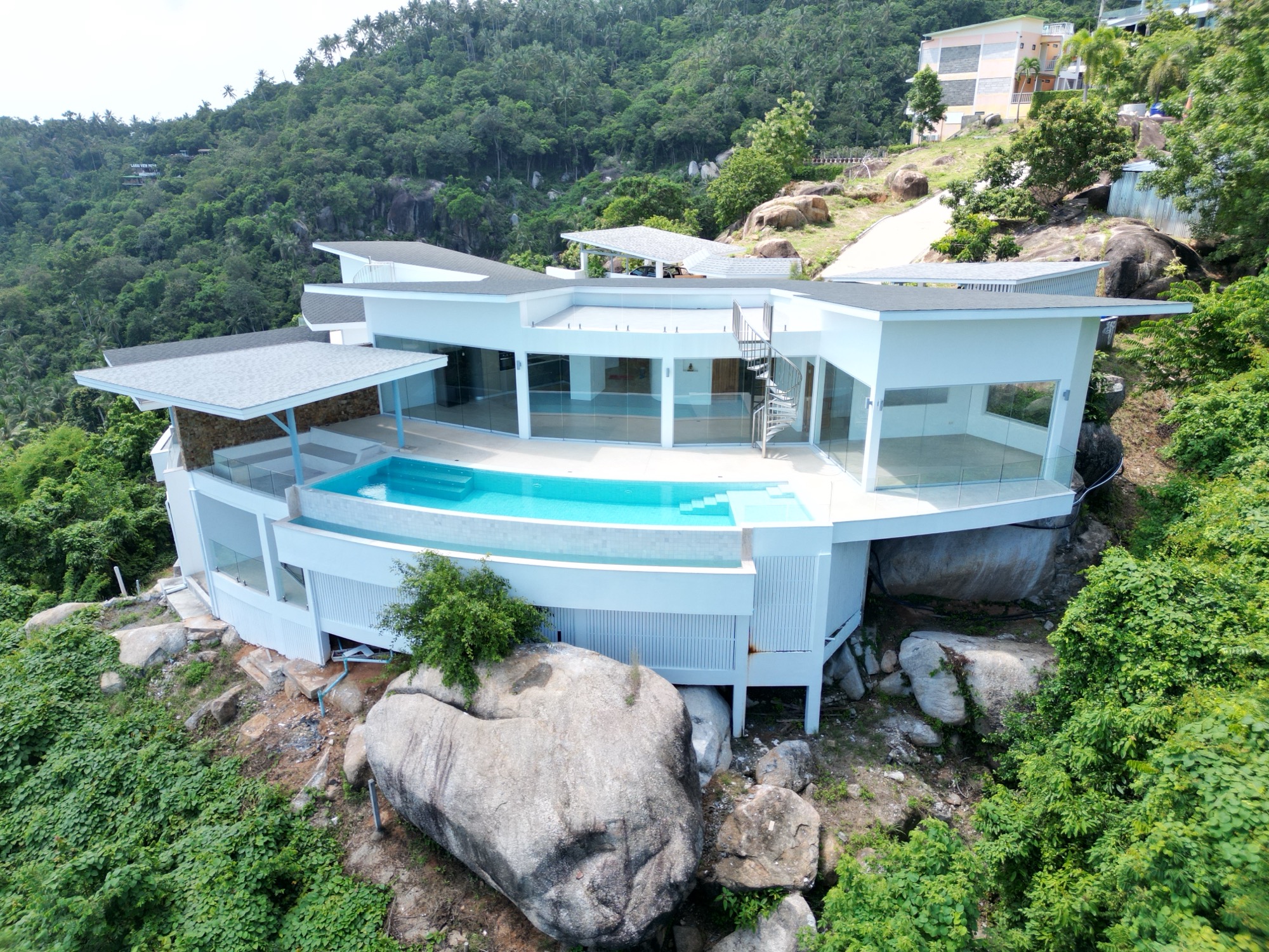 Villa 1 on the ridge above Lamai bay, its sweeping roofline and infinity pool set against the hillside