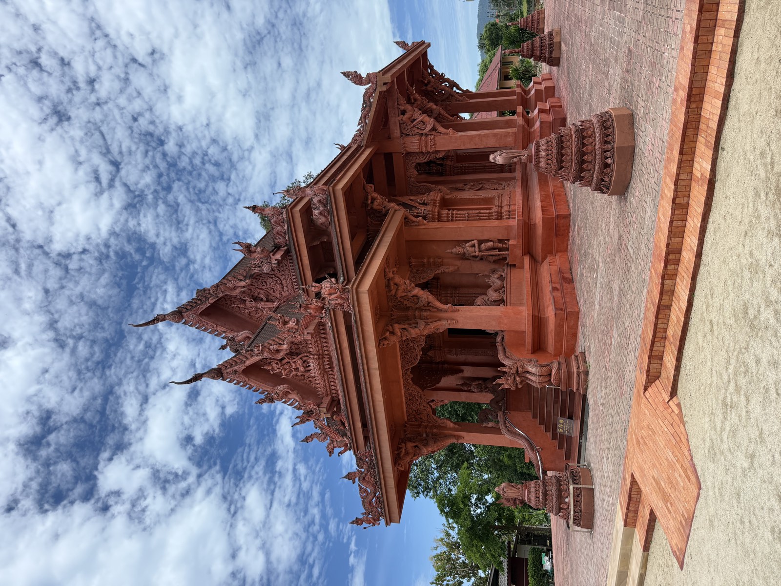 The Red Temple, Wat Ratchathammaram — carved crimson walls above the sea